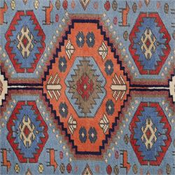 Caucasian Kazak hand-knotted rug, pale blue main field with large geometric medallions in a vertical arrangement and angular tribal motifs within a rosette and geometric border, cotton fringe end, 68x88cm