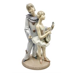 Lladro figure, Minstrel's Love, modelled as a couple entertaining, the lady in ballerina costume playing the lute and the gent stood behind her in jester type dress, sculpted by Rafael Lozano, with original box, no 5821, year issued 1991, year retired 1993, H31cm
