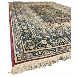 Persian design rug, rectangular crimson ground field with medallion, surrounded by trailing foliate branches, within wide border bands decorated with stylised floral motifs 