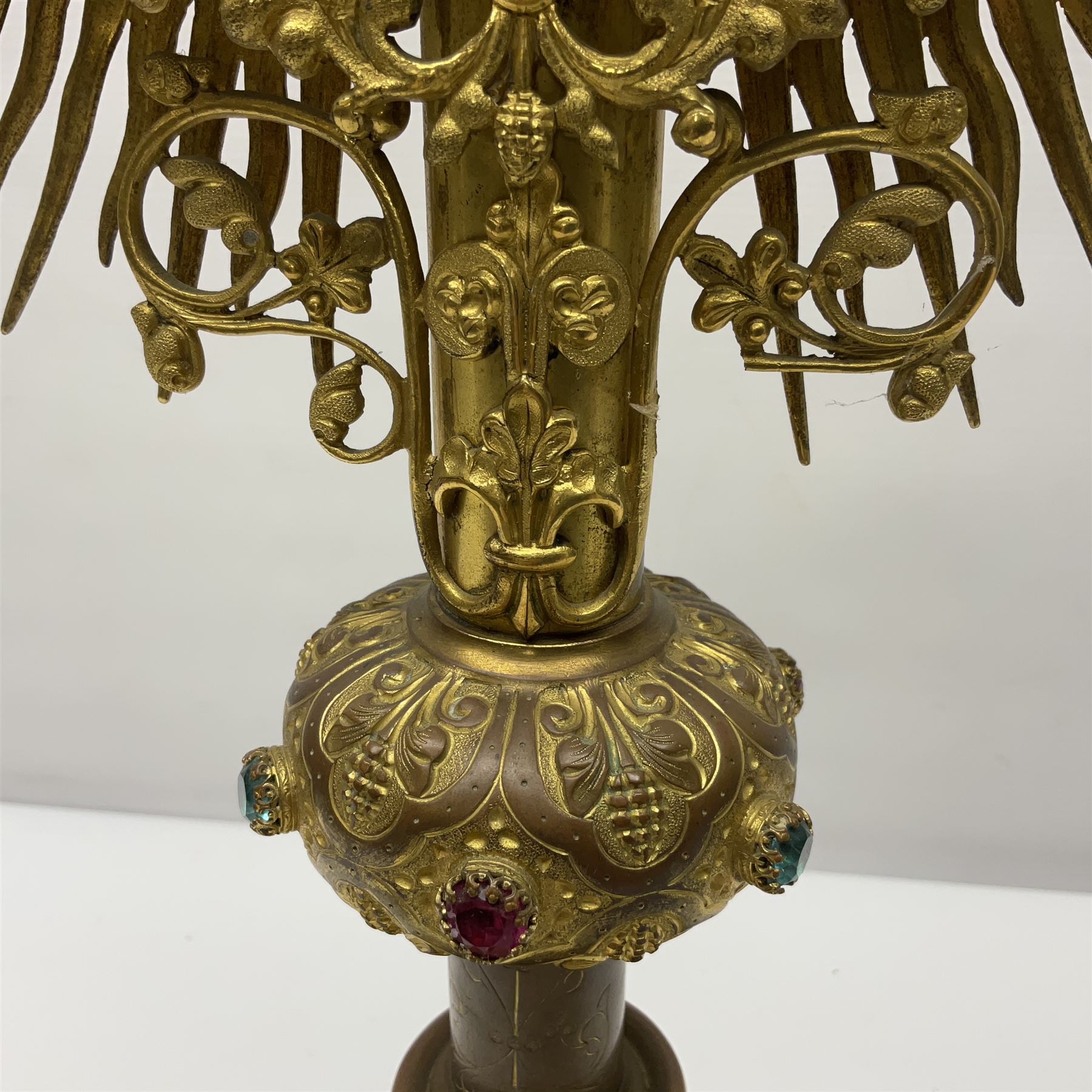 20th century gilt metal monstrance, in the Gothic revival style, with glazed aperture to centre surrounded with clear paste stones, in a pierced floral and scroll border set with coloured paste stones, within a sunburst surround, on a paste set knopped stem and similar foliate foot, H59.3cm