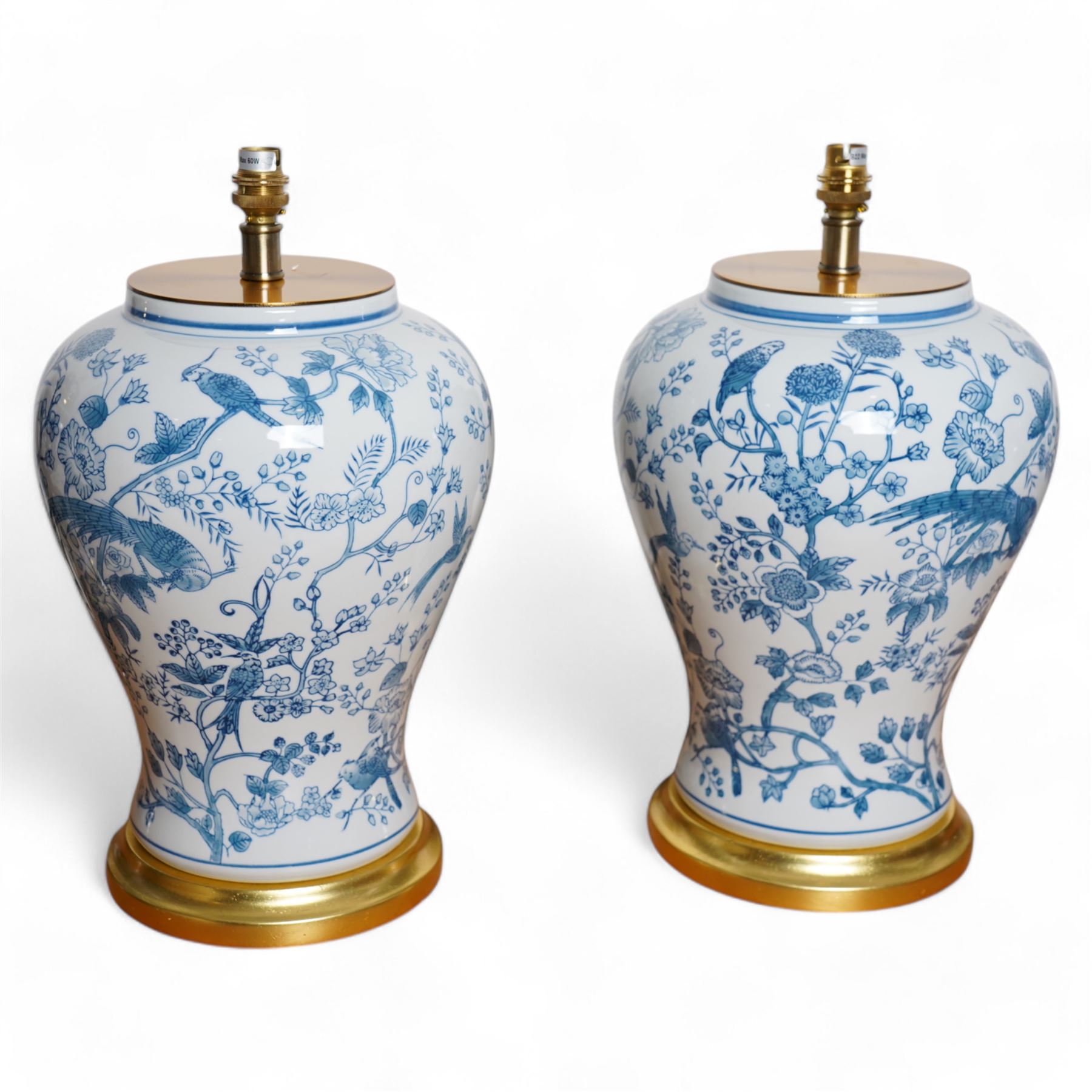Pair of large table lamps of baluster form, decorated with exotic birds perched in flowering trees, upon gilt circular bases,  H68cm including shade