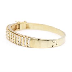 14ct gold diamond hinged bangle, fifteen rows each channel set with three round brilliant cut diamonds, stamped 14K, total diamond weight approx 3.15 carat