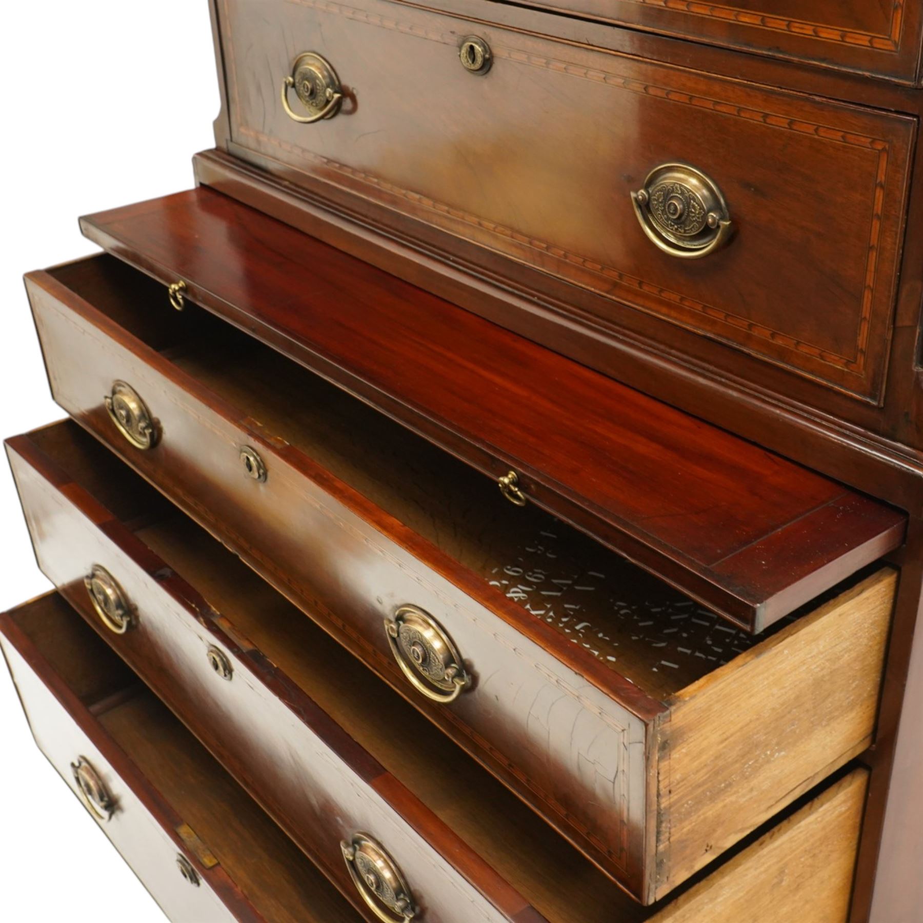  Late 18th century mahogany and inlaid chest on chest, projecting cornice above blind fretwork in laid drawers, the upper chest with two short over three graduating drawers, the lower section with brushing slide over three long graduated drawers, raised on bracket feet