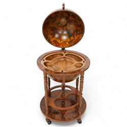 Late 20th century drinks globe, hinged lid enclosing drinks holders, on turned supports