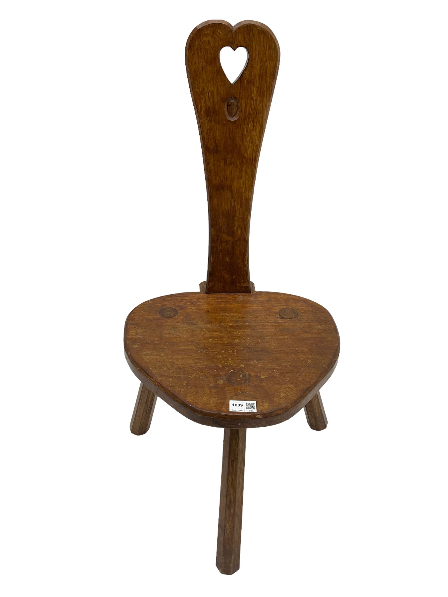 Acornman - adzed oak spinning chair, spoon shaped back with pierced heart and acorn signature, spade-shaped seat raised on octagonal tapering supports by Alan Grainger of Brandsby