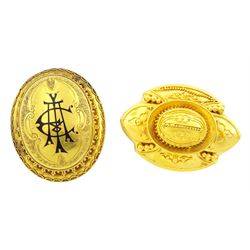 Victorian gold hinged locket brooch, the monogrammed black enamel front revealing hairwork glazed locket and an Victorian 18ct gold Etruscan design brooch