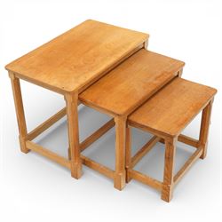 Mouseman - oak nest of three tables, raised on octagonal supports with signature mouse car...