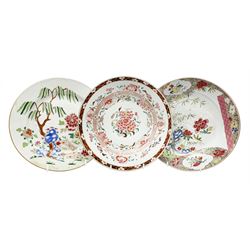 Three 18th Chinese plates, decorated in the Famille Rose pallet with various motifs including peonies, prunus blossom, willow, rockwork and fence, each approximately D13cm