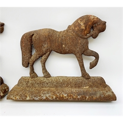  A pair of cast iron door stops, each modelled as a horse, H24cm L30cm.   