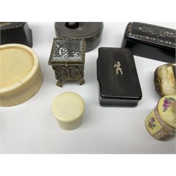 Group of 19th century and later snuff and other boxes, to include black papier mache example with mother of pearl decoration to the hinged cover, horn example with naïve inset decoration of a figure, turned treen example, tack box with cover surmounted with figure, Continental porcelain box and cover decorated in the manner of Helena Wolfsen with spurious beehive mark beneath, etc. 