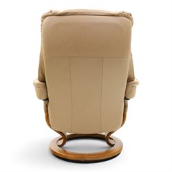 Ekornes Stressless - beech framed reclining swivel armchair with matching footstool, on U-shaped supports with circular bases, upholstered in beige leather