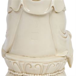 Three Chinese blanc de chine, each depicting Guanyin seated, Dehua province, two with double gourd and potters seal marks to the reverse 
