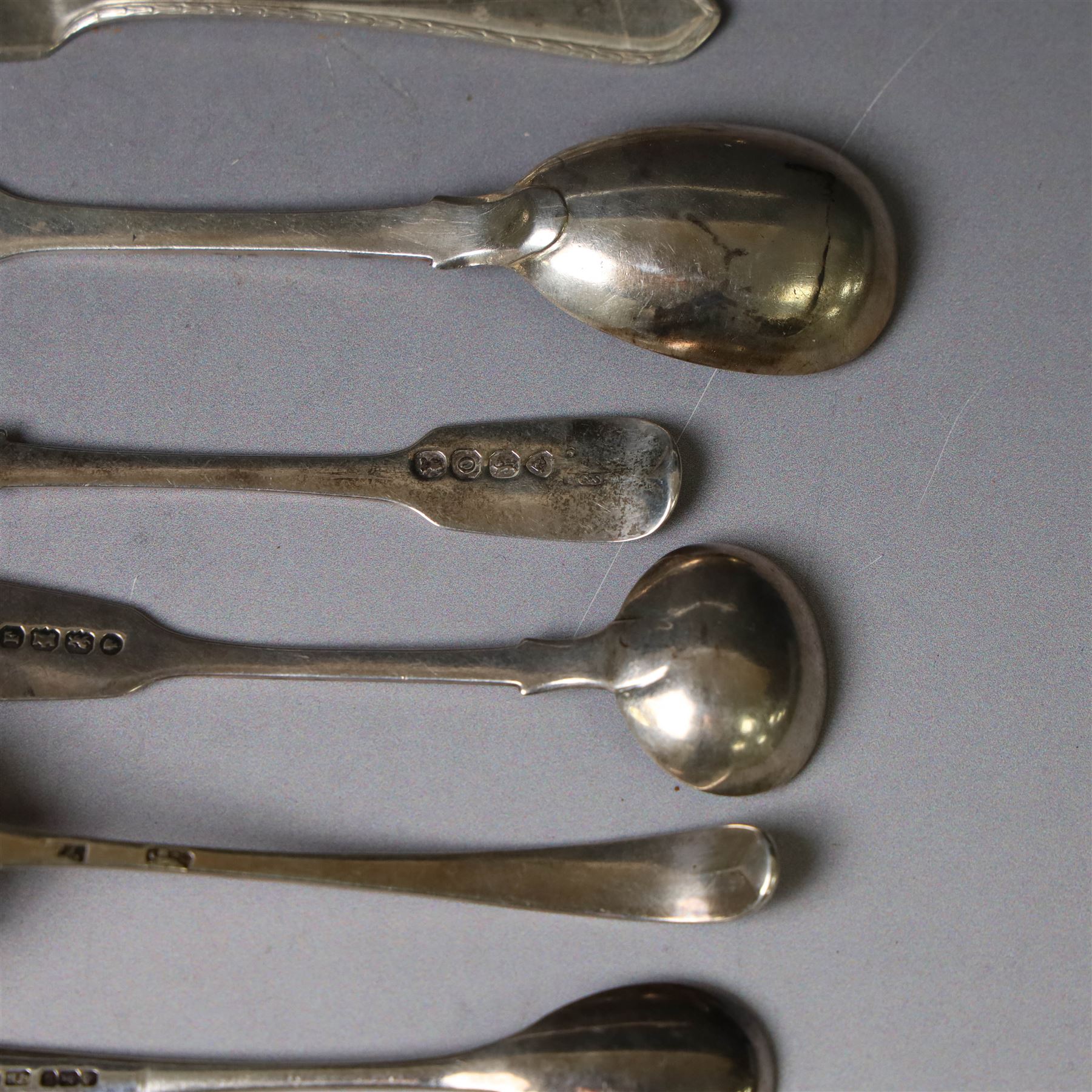 George III silver marrow scoop, hallmarked London 1767, makers mark indistinct, together with a collection of silver condiment spoons and butter knives, all hallmarked