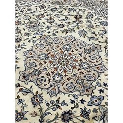 Persian Kashan ivory ground carpet, decorated all-over with interlacing foliate and stylised plant motifs, central scrolling medallion and matching spandrels, the guarded border decorated with repeating palmettes