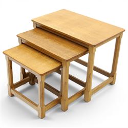 Mouseman - set of three adzed light oak nesting tables, each with rectangular top raised o...