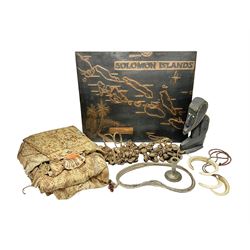 Collection of traditional necklaces from the Solomon Islands, including shell and boar tusk examples, together with a carved canoe prow, with mother of pearl eyes, painted cow hide and a copper plaque, depicting the Solomon Islands, with presentation engraving