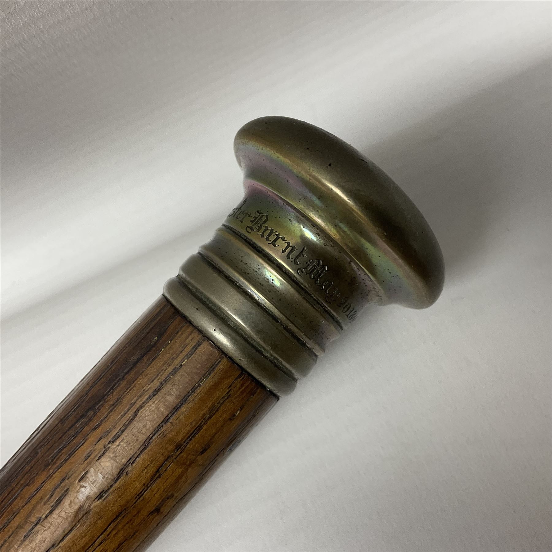 Three early 20th century walking sticks, to include a smoking pipe walking stick, the cane opening to reveal a concealed pipe, and a wooden walking cane, the metal cover with inscription 'bell metal and wood of York Minster, Burnt May 20 1840, and a turned wooden walking stick, with marquetry checkerboard pommel, tallest L90cm
