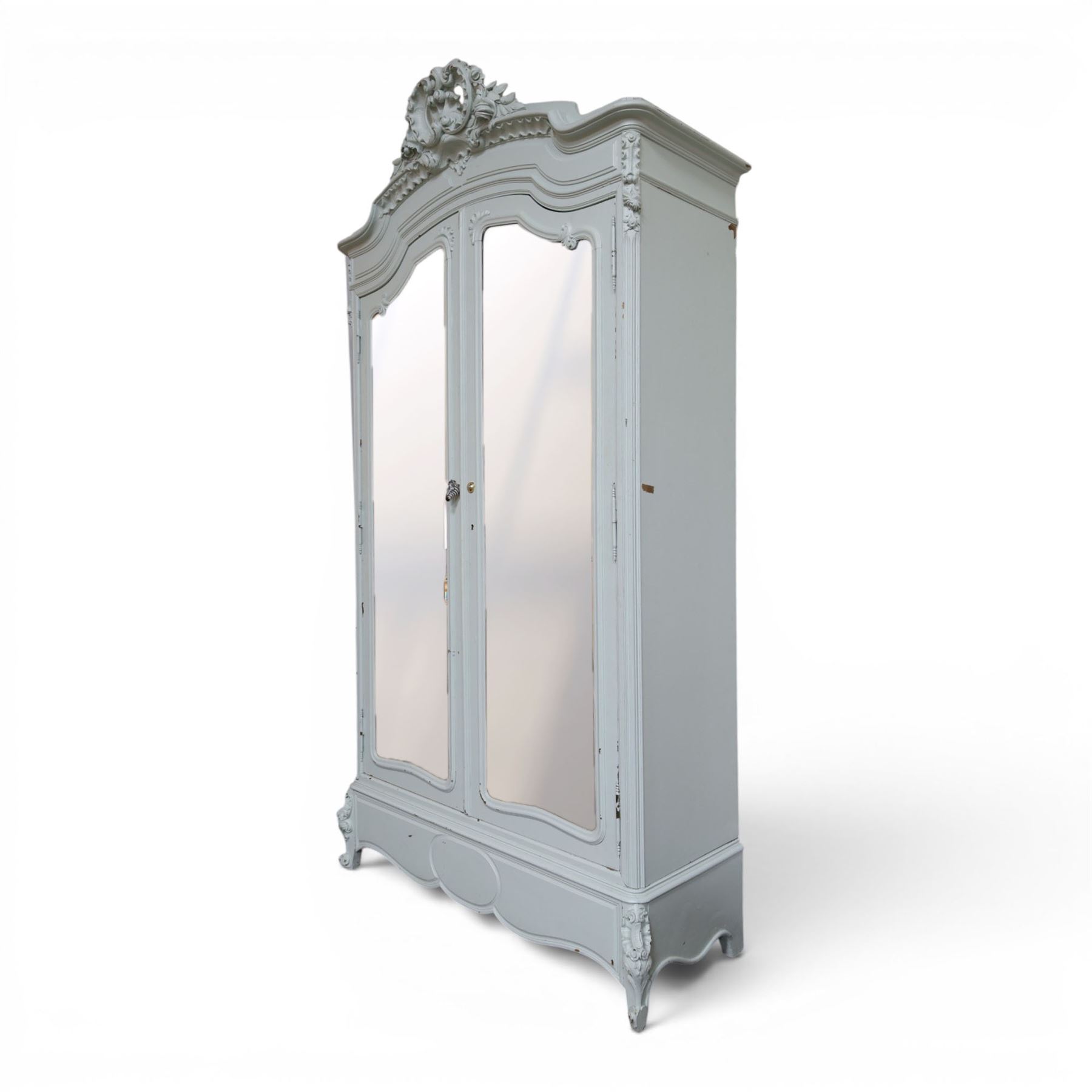 French Louis XV style pale blue painted armoire, with carved floral and foliate crest over a shaped moulded cornice, fitted with two bevelled mirror panel doors enclosing hanging space and drawer, above shaped apron, raised on carved cabriole supports