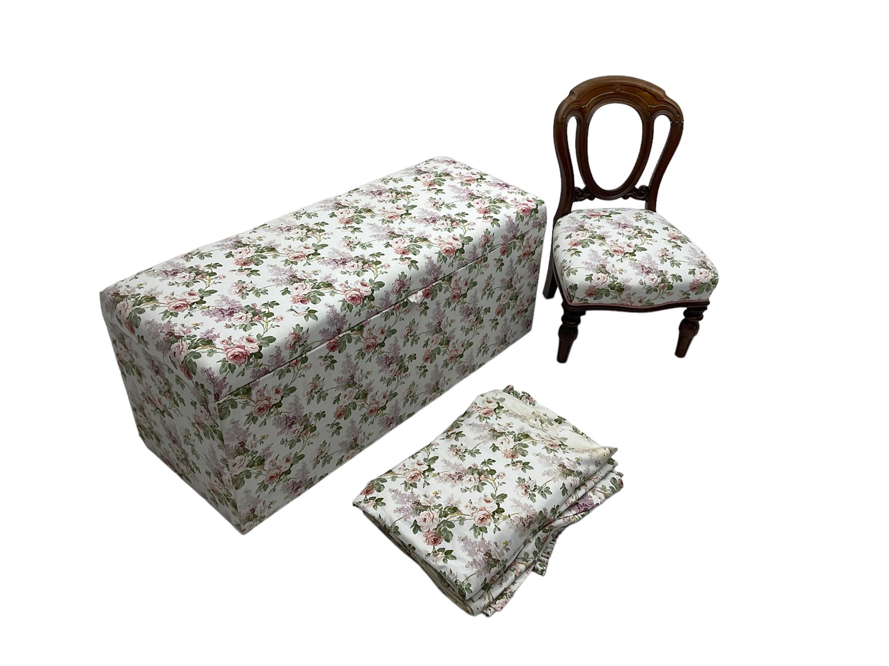 Ottoman blanket box upholstered in floral pattern fabric, matching bedroom chair and curtains