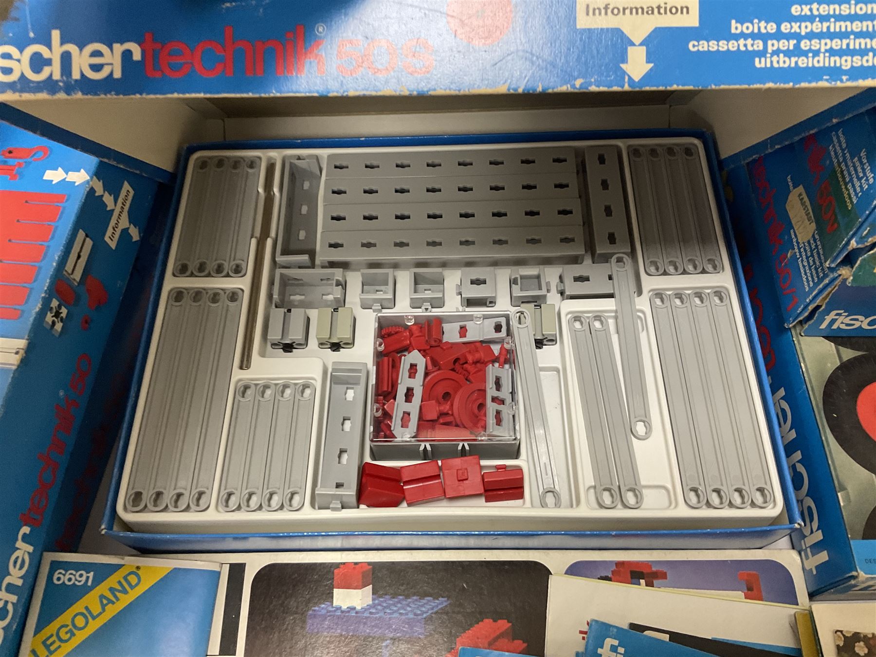Fischer Technik/Lego/Playmobil - thirteen model building sets comprising eight Fischer Technik sets 50, 50/1, 50v, 50/2, 50+mot1 and two 50S, 50/1 add-on pack, with spare parts packs 01, 03, 05, two 22 and 30; two Lego sets comprising C107 and Lego Systems 103, part-set 870 and 970; Playmobil no.3520 set; four boxes of loose lego, various instruction manuals and a scrapbook 