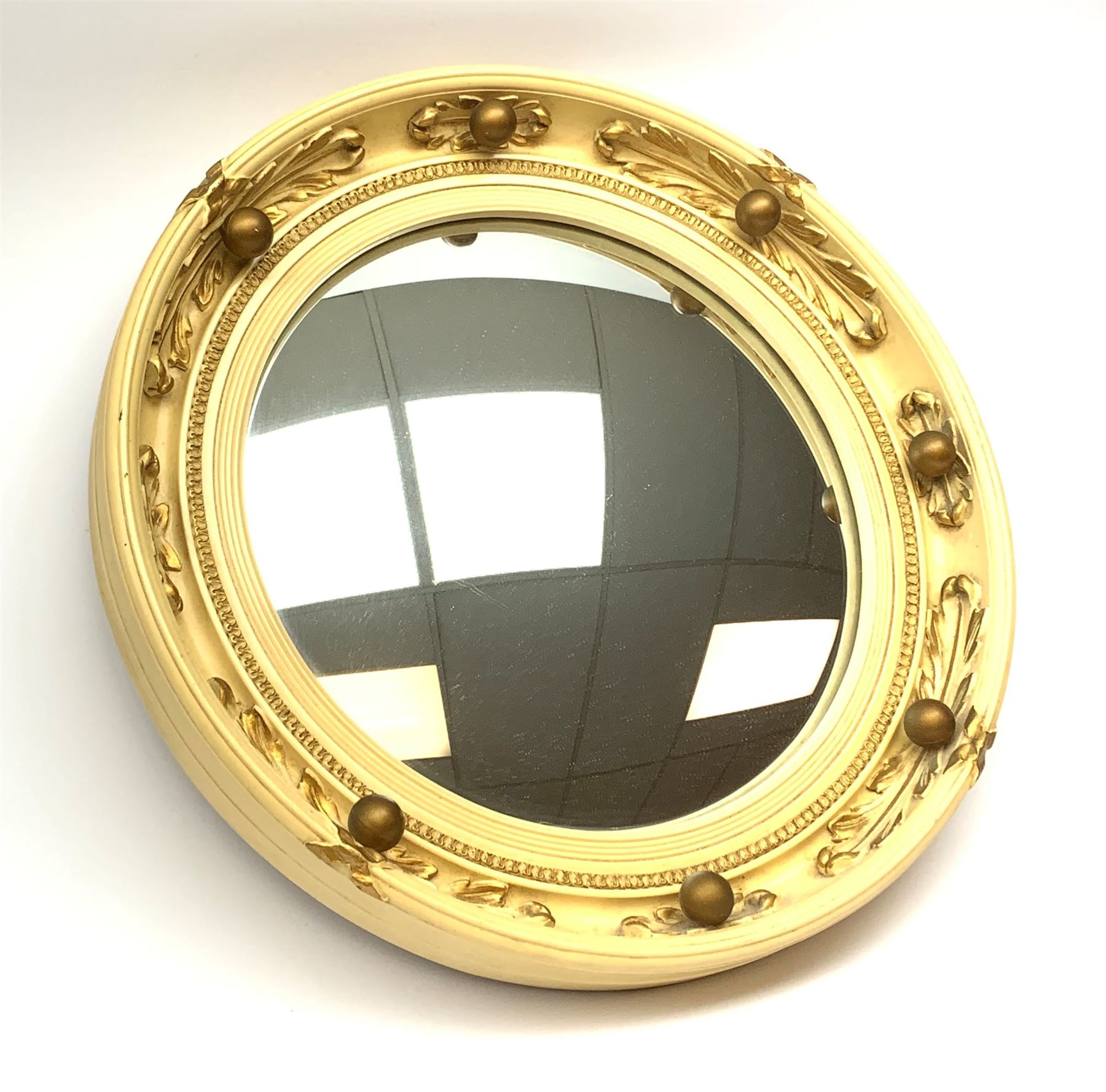 A vintage Atsonea convex mirror, of circular form, the cream frame with gilt detail, D41.5cm.