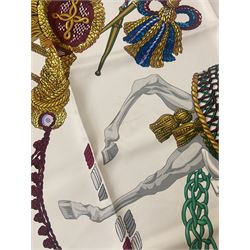 Hermès 'Le Timbalier' silk scarf, designed by Francoise Heron in 1961, printed with a central image of a gentleman on horseback donning extravagant dress, on white ground surrounded with colourful stylised knotted ropes, contained within peacock blue border, with rolled hand stitched edges and Hermes material label, 87cm square