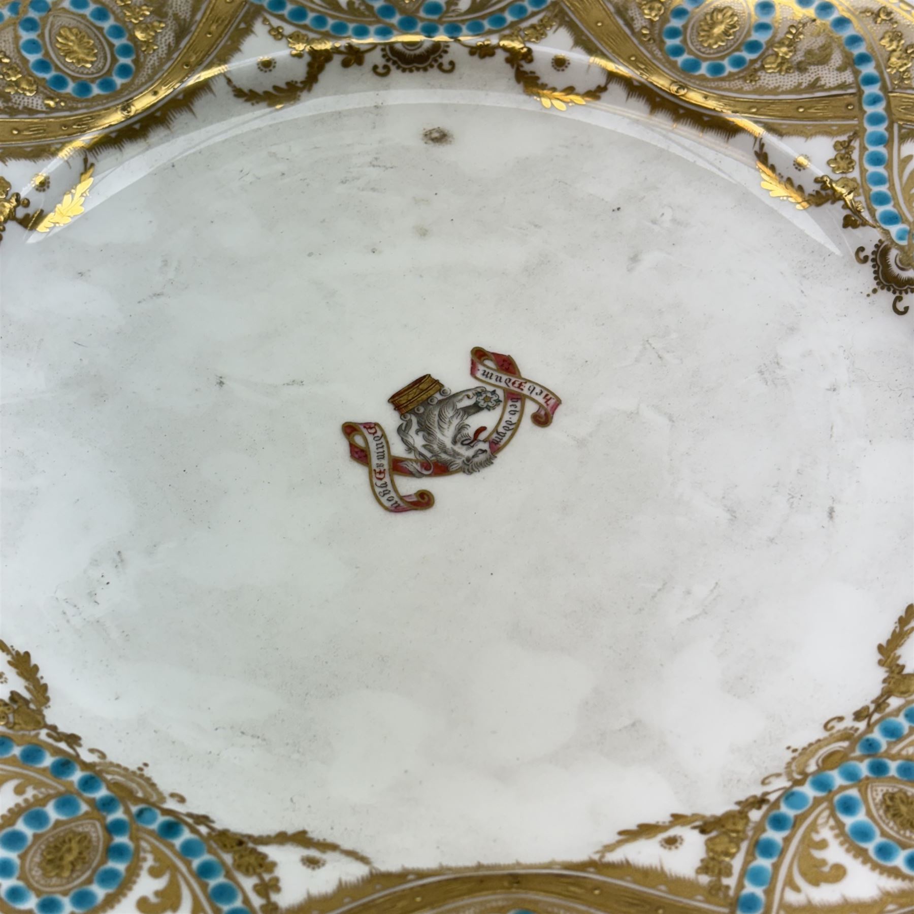 Pair of 19th century H&R Daniel porcelain armorial plates, each decorated with a central painted lion crest and banner inscribed with the Lloyd family motto in Welsh, 'Heb dduw heb ddym, Dhuw a digon' (Without God without anything, God is enough), within a gilt detailed and turquoise jewelled rim, each with puce printed mark verso, D26cm