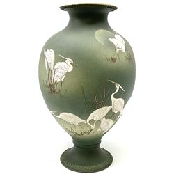 20th century Japanese vase, of pronounced baluster form, with waisted neck and spreading circular foot with beaded detail, the green matt body hand painted with cranes amidst grasses, H31cm