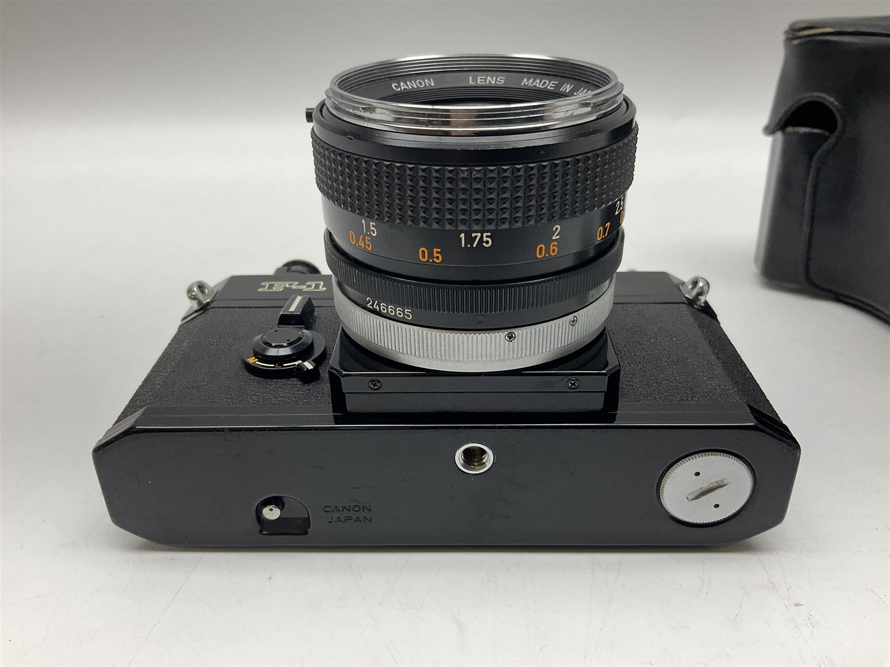Canon F1n camera body, serial no. 572972, with 'Canon FD 50mm 1:1.4' lens, serial no. 246665, with leather case 