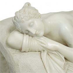 After Antonio Canova (Italian 1757-1822): 'Sleeping Venus', an Italian carved white marble figure of a reclining nude, the serene figure depicted lying on her side, her head resting on a cushion and one knee gently raised, a loosely draped sheet partially covering her lower body, on a rectangular base with rough-hewn surround, raised on a marble plinth over a sarcophagus style pedestal, circa 1900

Provenance: Kirkham Hall

Notes: A late-19th-century homage to Canova’s neoclassical models, reflecting the Grand Tour taste for idealised classical beauty and the refined finish characteristic of Italian workshop marbles of the period