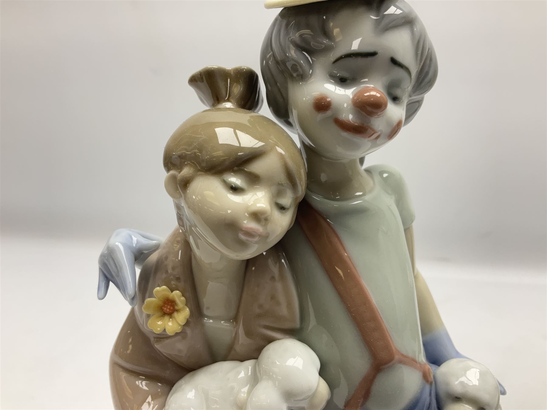 Three Lladro figures, comprising Little Jester no 5203, Pals Forever no 7686 and Naughty Girl no 5006, H25cm