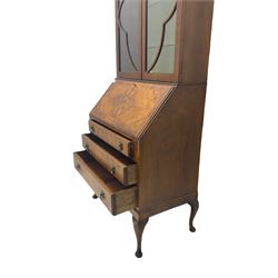 Early 20th century walnut bureau bookcase, two glazed doors over fall front, fitted with three drawers, on shell carved cabriole feet