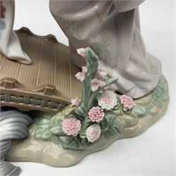 Lladro figure group, Springtime In Japan upon a plinth, modelled as two Geisha on a bridge with a crane, sculpted by Salvador Debonno, no 1445, with original box, H30cm