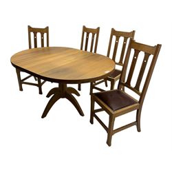 Contemporary light oak round extending dining table with four chairs, table has fold out leaf attached underneath on four out-swept legs, Oak chairs with straight top rail over twin slat back with pierced motifs, brown leather seat with brass studs, square legs joined by plain stretcher 
