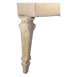 Pair of contemporary hardwood corner chairs, upholstered in broad alternating bands of neutral-toned fabric, each with two knotted rope buttons to the backrest, the whole raised on turned and lightly whitewashed supports terminating in castors