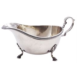 Mid 20th century silver sauce boat, of typical form with scroll handle, upon three hoof feet, hallmarked Harrods Ltd, Sheffield 1960, approximate weight 5.69 ozt (177 grams)