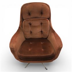 Pair of mid 20th century brown velvet swivel lounge chairs and matching footstool, the shaped and padded back with buttoned segmented cushion over conforming seat cushion, flared armrests and moulded sides, raised on a five point metal swivel base, the footstool en suite with buttoned cushion and matching metal base
