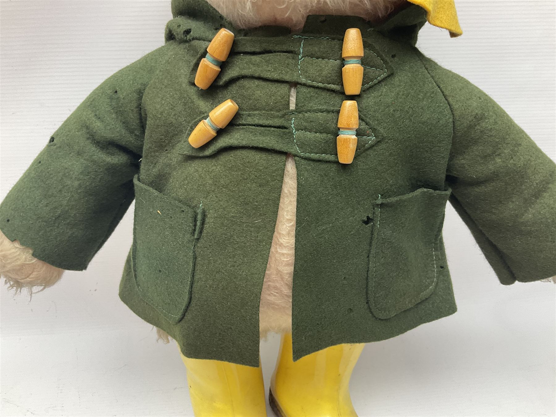 Vintage Paddington Bear teddy with yellow felt hat, green coat and yellow Dunlop boots, H48cm
