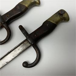 Two 19th century French model 1874 epee bayonets, each with 52cm steel blade, and armoury dates for 1880 and 1881 L64cm overall (2)