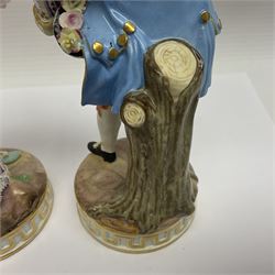Pair of late 19th/early 20th Century Meissen figures, modelled as flower sellers, after the original by Michel Victor Acier, she holding basket of flowers, he holding flowers in his hat, each with underglaze cross swords mark beneath, tallest H16.5cm