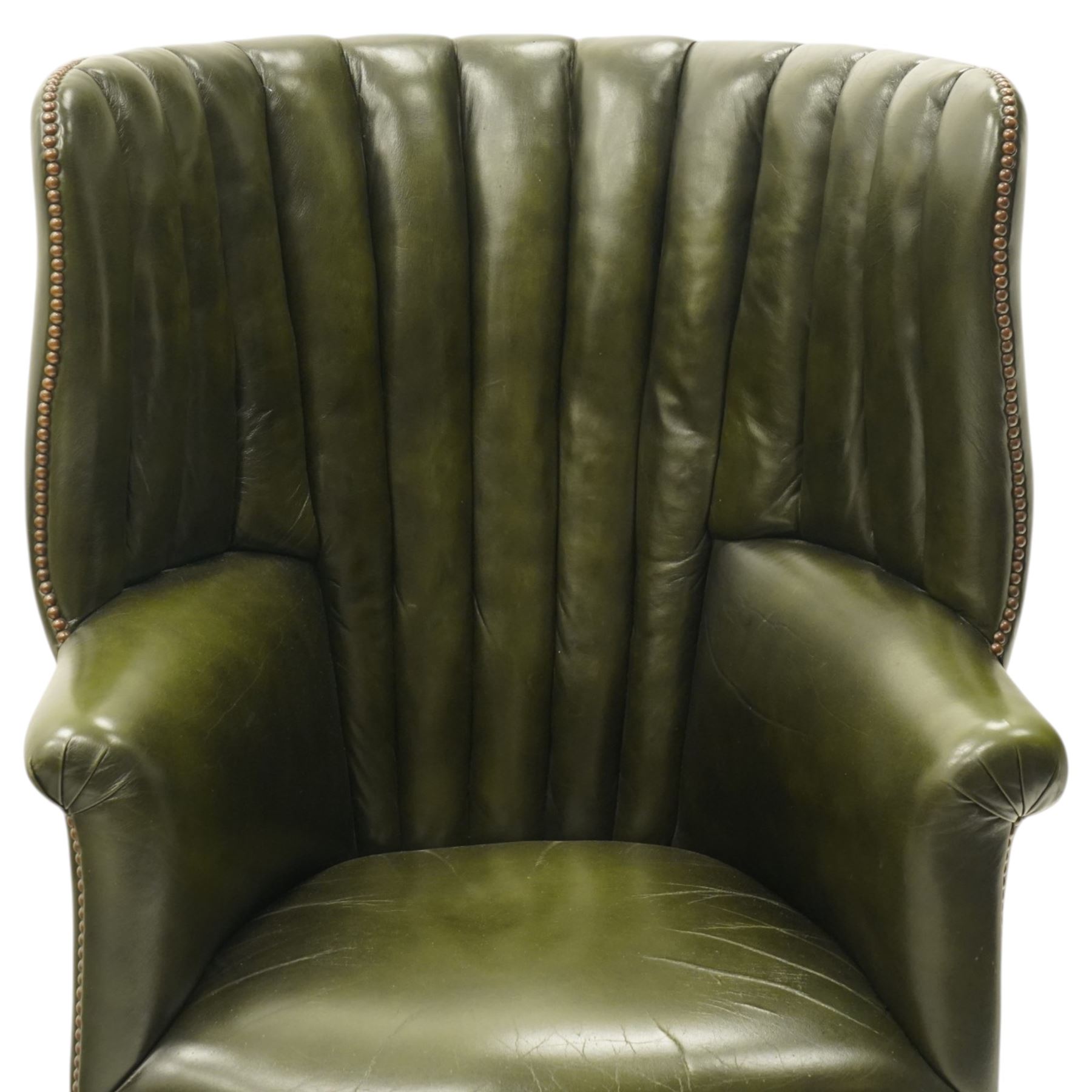 Georgian design green leather barrel-back wingback armchair, pleated upholstered back with shaped wings over scroll arms and sprung-seat, close nailed border, raised on cabriole supports terminating in pad feet