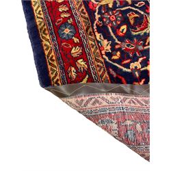Persian Sarouk rug, blue ground with central floral medallion, decorated all-over with interlacing branch and flower head motifs 