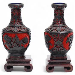 Three Chinese red and black cinnabar lacquered vases, together with three metalware examples, possibly 19th century Islamic, comprising vase, cup and covered vessel with floral handle; and a carved soapstone pig (7)