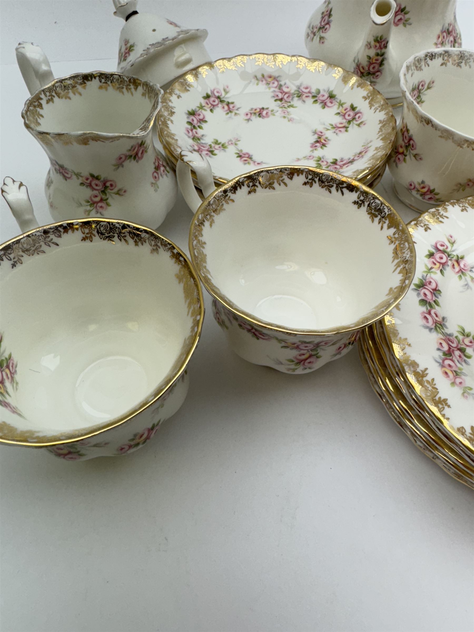 Royal Albert Dimity Rose pattern tea service for six place settings, including teapot, teacups and saucers, sugar bowl and two milk jugs, all with printed mark beneath