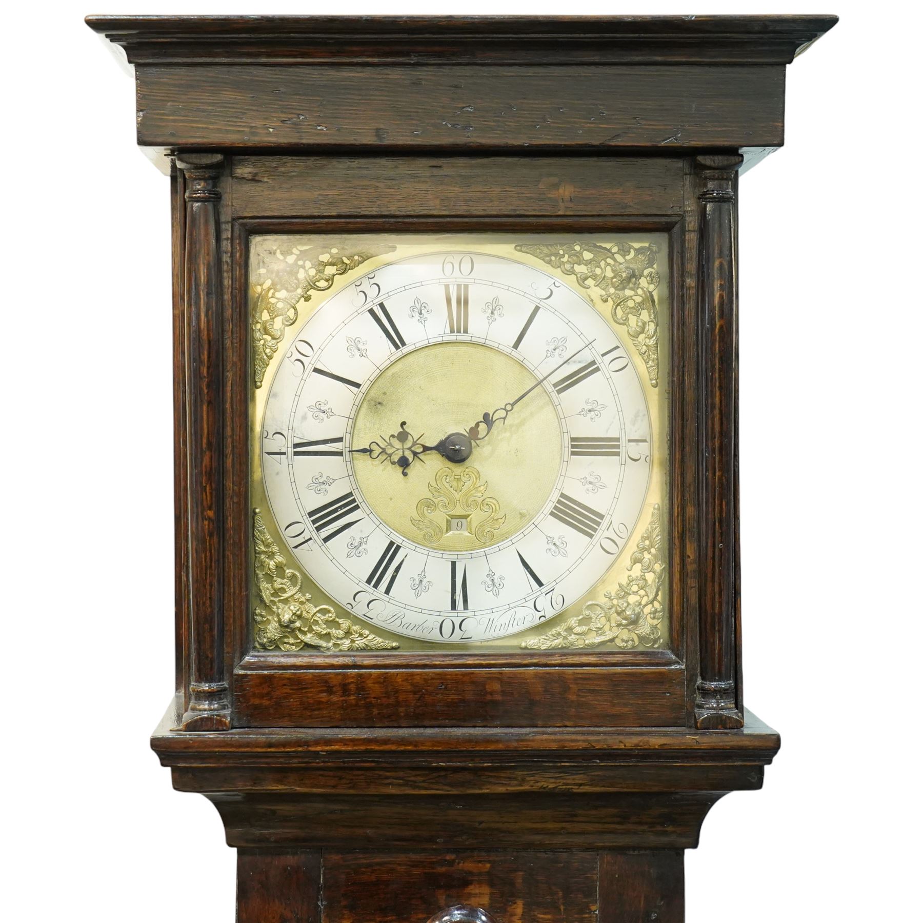 Jonas Barber of Winster (Westmoreland), provincial mid-18th century ash and oak cased 30-hour longcase clock, hood with a flat pediment, square hood door and attached pilasters, trunk with a full length shaped door on a square plinth with an applied skirt, brass dial with cast cherub spandrels, plain dial centre with date aperture and steel hands, silvered chapter ring engraved with Roman numerals, five minute Arabic's, quarter hour and minute tracks with half-hour markers, chain driven countwheel striking movement striking the hours on a bell. With weight and pendulum.
