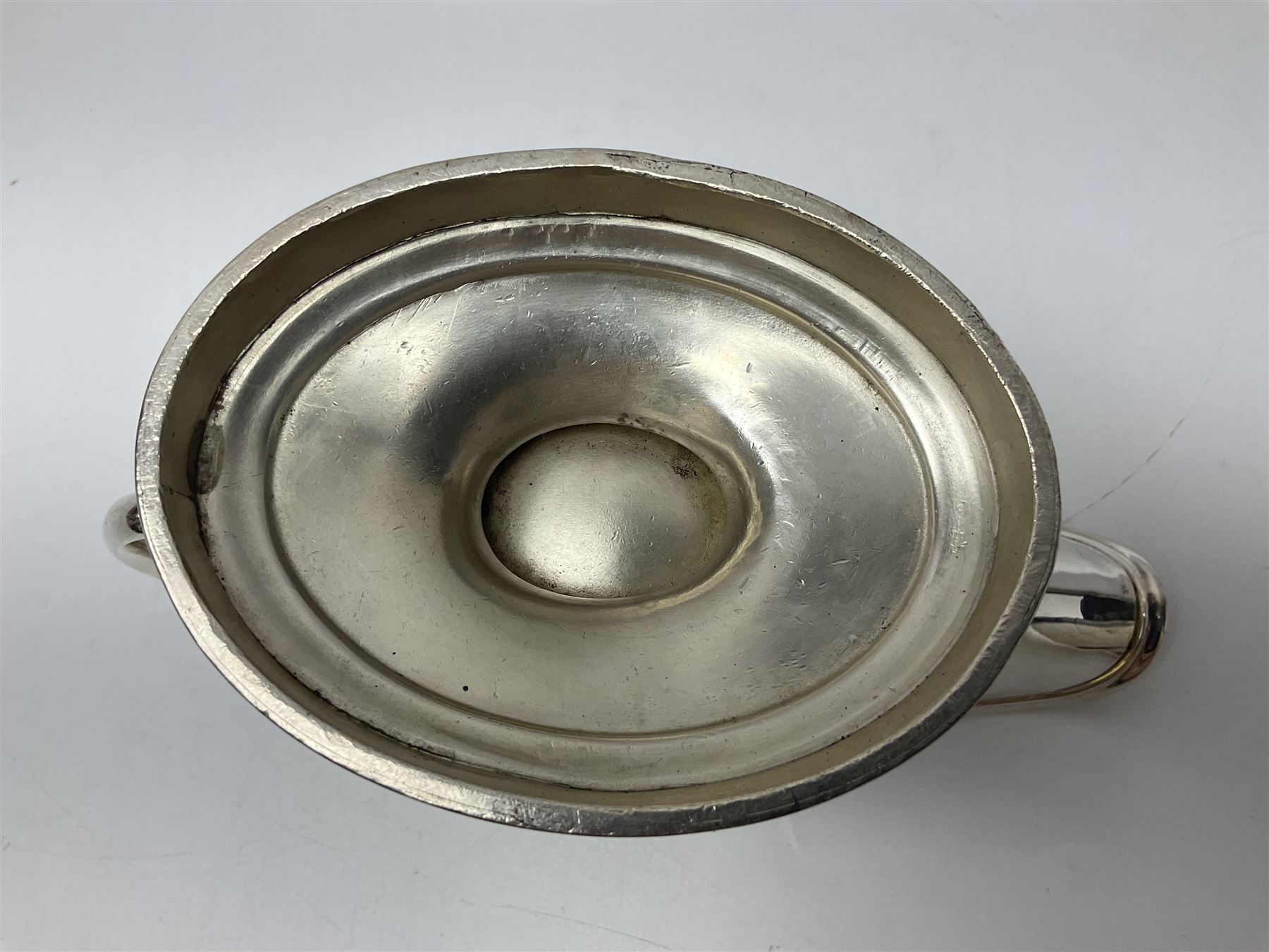 Christofle silver-plated sauce boat, of typical plain form, with capped C scroll handle and engraved anchor crest to body, upon a stepped oval foot, stamped 22 Christofle to base, including handle H14cm