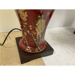 Pair of large lamps of tapering form, decorated with Japanese blossom on a red ground upon a square base, including shades H72cm