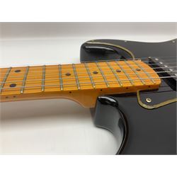 Copy of a Fender Stratocaster electric guitar in black with Wilkinson bridge, lock-in tuners, synchronised tremolo and various patent numbers; L99cm; in hard carrying case with strap and digital tuner