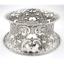 Edwardian silver dish ring in the Irish manner, of circular waisted form, embossed and pierced throughout with flower heads and foliate and C scrolls, hallmarked I S Greenberg & Co, Birmingham 1904, with accompanying blue glass liner, upper rim D17.5cm, approximate weight 6.84 ozt (213 grams)