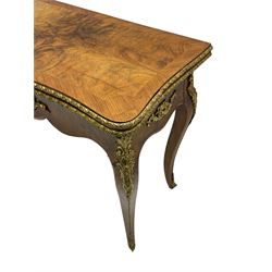 20th century French walnut and Kingwood card table, shaped fold-over top with figured quarter-matched veneers and floral egg and dart moulded edge in gilt metal, shaped aprons decorated with shell motifs with extending foliage, pull-out action base revealing storage well, on cabriole supports with ornate gilt metal mounts 